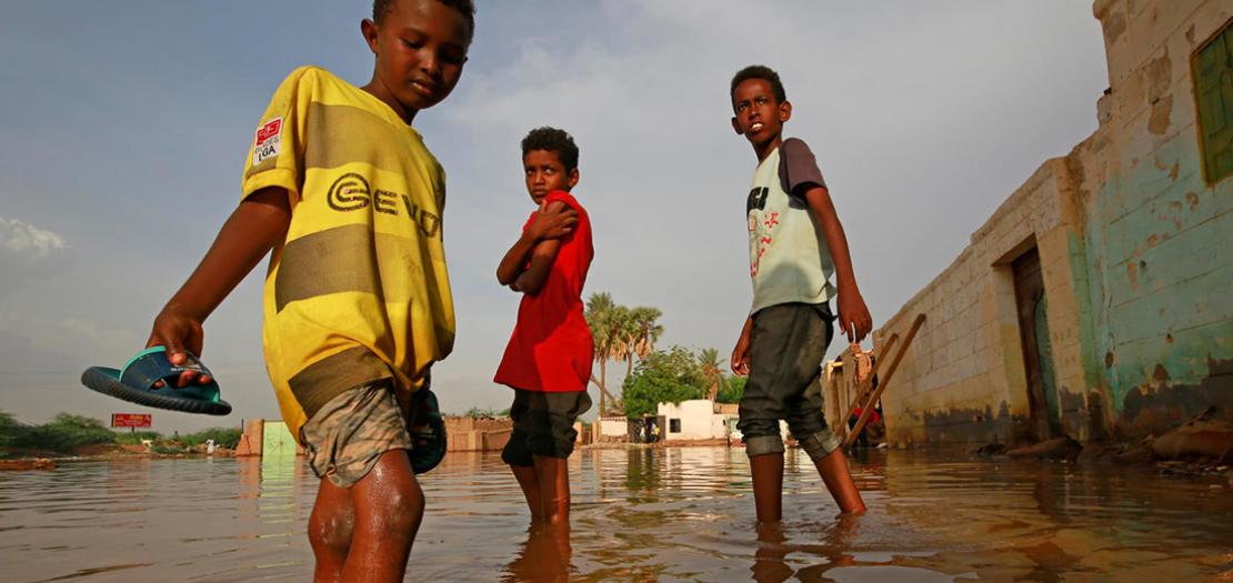 صبية سودانيون في شارع غمرته المياه في أم درمان، 26 آب 2020